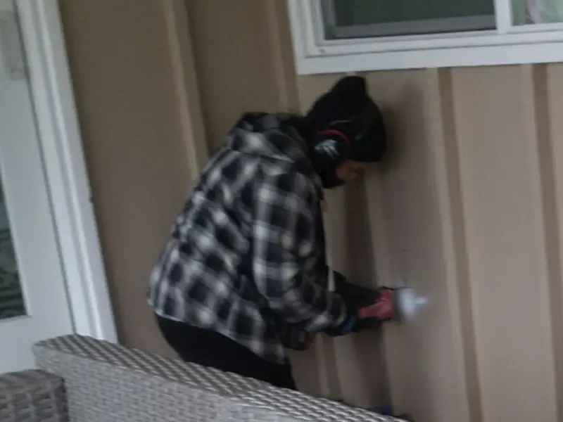 Professional electrician installing an exterior outlet in Highfill